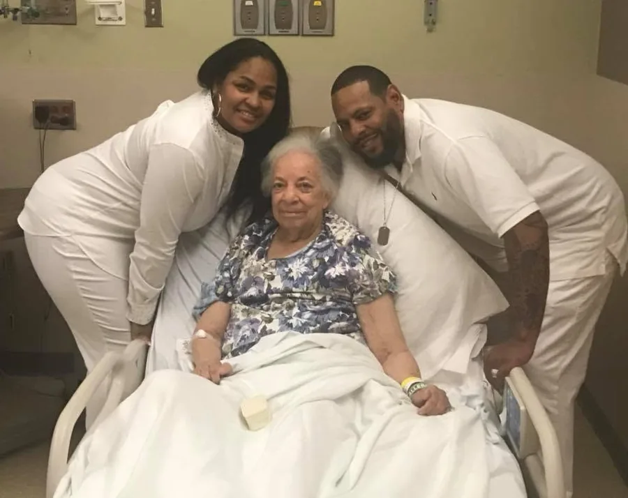 Family members at Elaine’s bedside, leaning in close and smiling